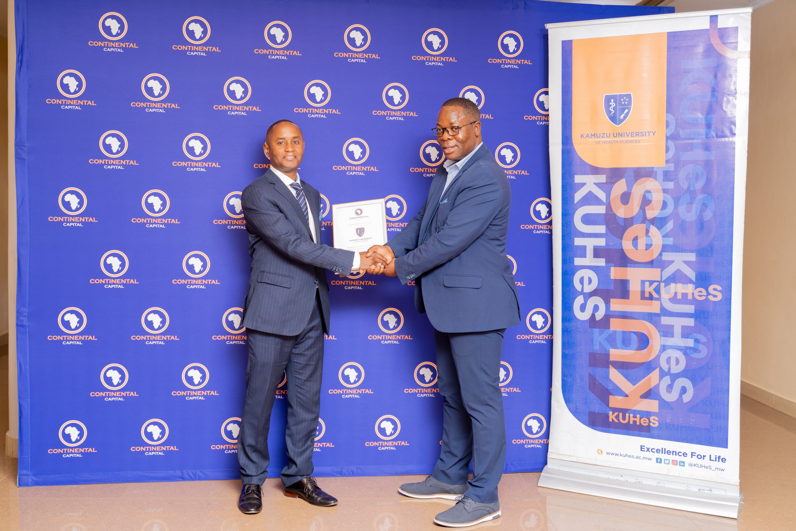 CCL General Manager, Kenneth Mmadi (left), presents a commemorative plaque to Dr. Benjamin Kumwenda, Director of Student Affairs at KUHeS