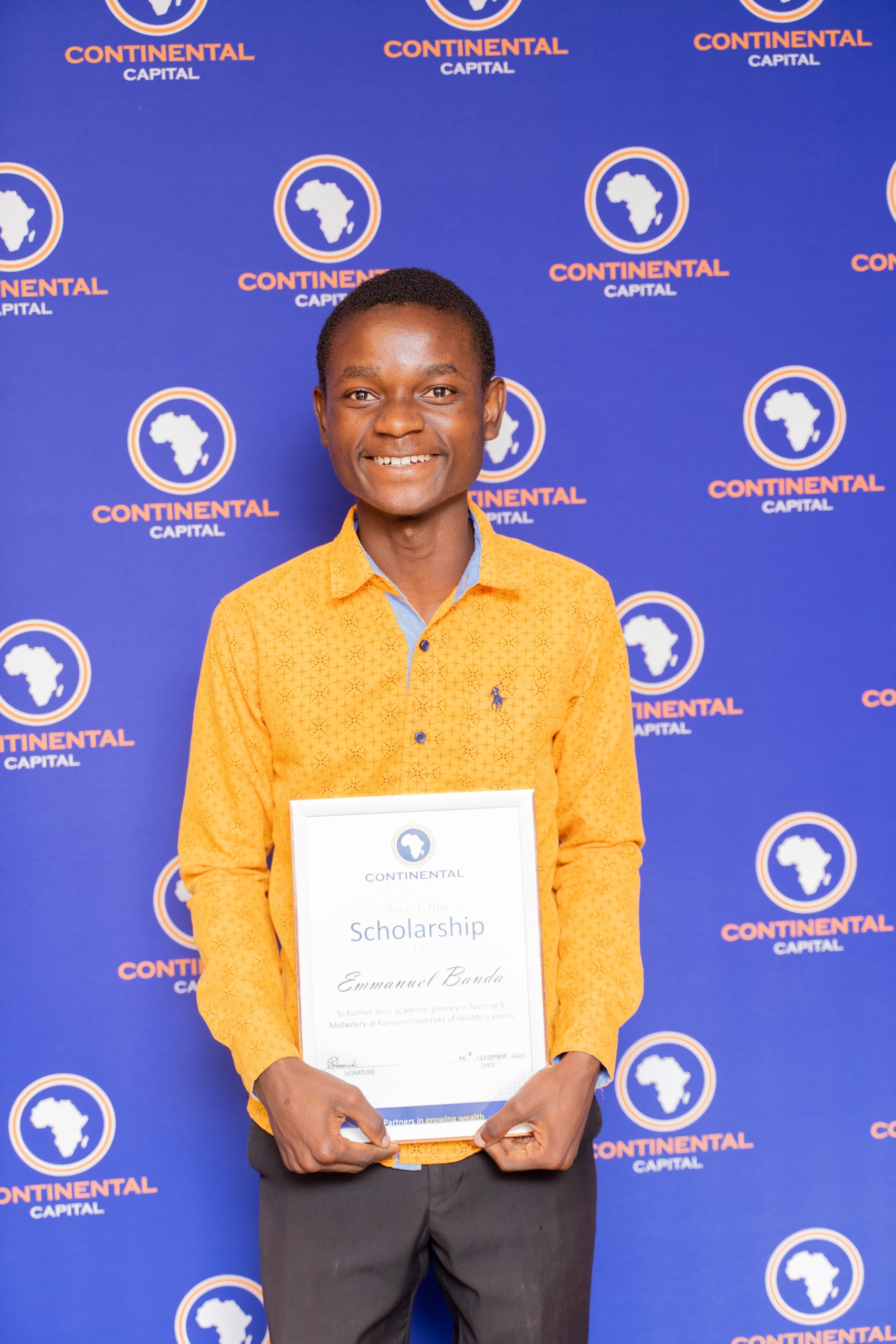 Beaming with joy: Emmanuel Banda, one of the scholarship recipients, proudly displays the certificate pledging CCL's support for his education
